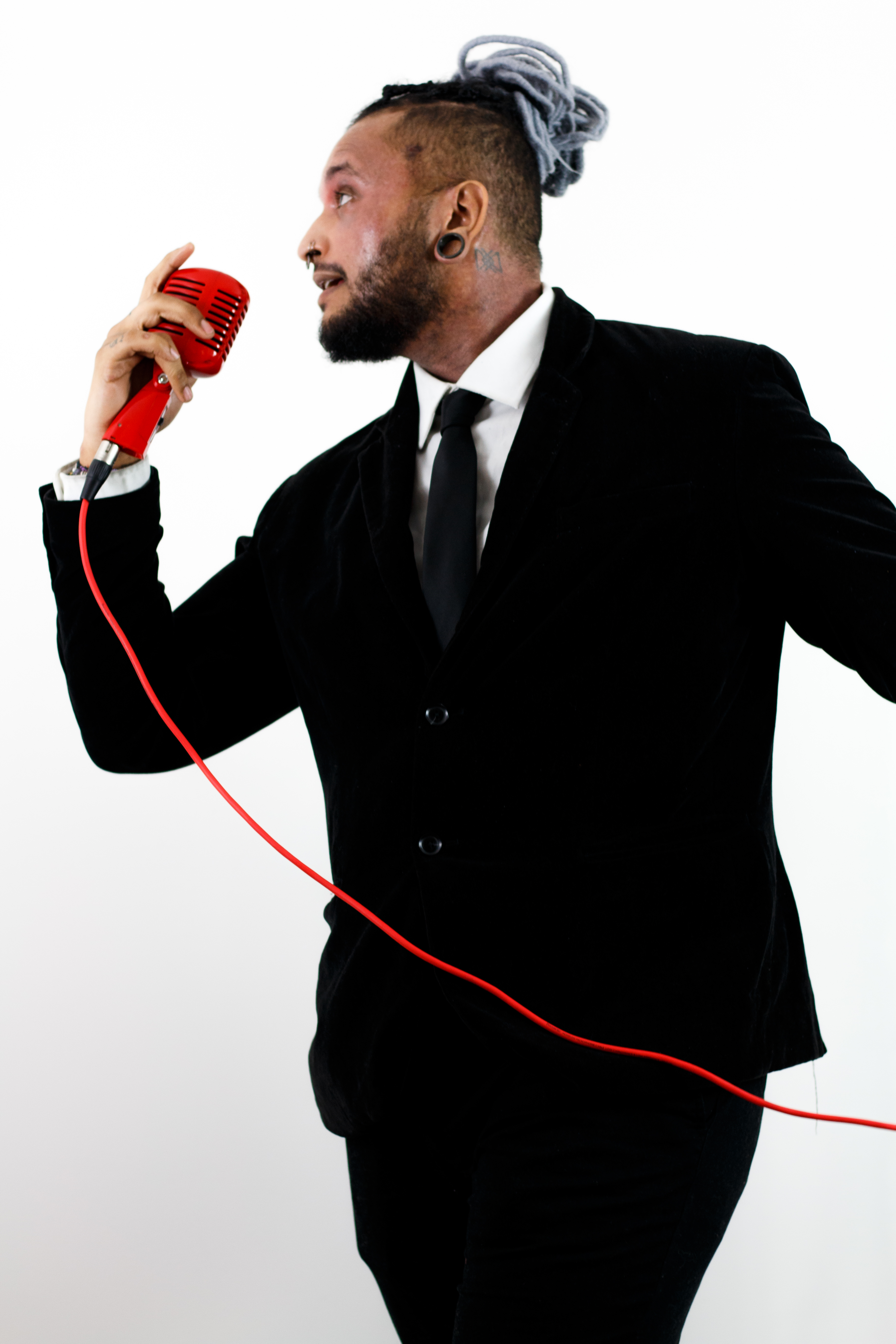 Danny Moon performing with red microphone